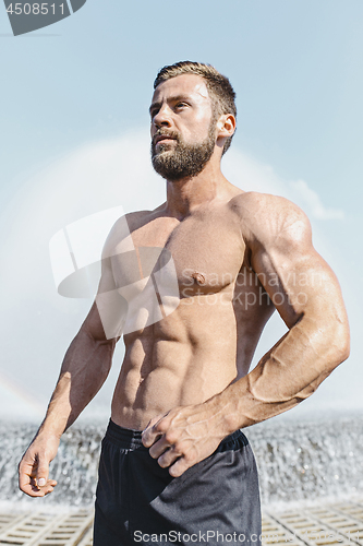 Image of Fit fitness man posing at city