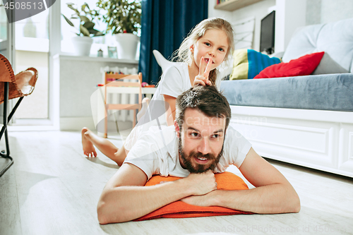 Image of Father and his six years kid girl at home