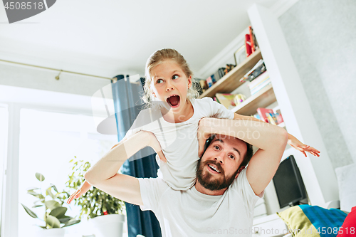 Image of Father and his six years kid girl at home