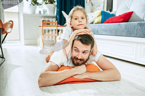 Image of Father and his six years kid girl at home