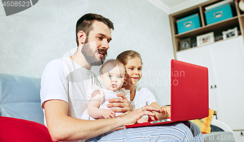 Image of father and his daughters at home