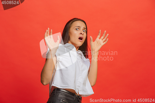 Image of Portrait of the scared woman on red