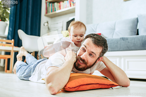 Image of father and his baby daughter at home