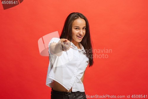 Image of The happy business woman point you and want you, half length closeup portrait on red background.