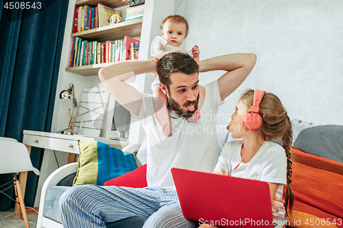 Image of father and his daughters at home