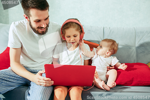 Image of father and his daughters at home