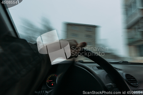 Image of Riding behind the wheel of a car in winter