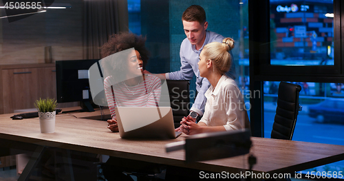Image of Multiethnic startup business team in night office