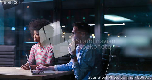 Image of Multiethnic startup business team in night office
