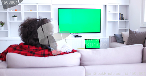 Image of Young couple on the sofa watching television