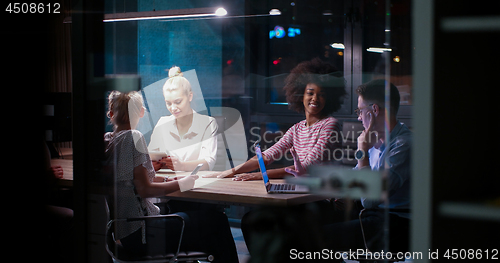 Image of Multiethnic startup business team in night office