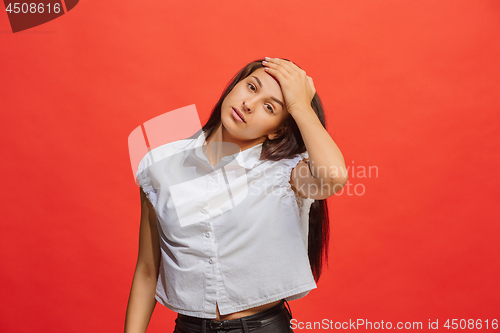 Image of Woman having headache. Isolated over red background.