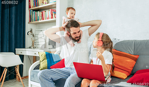 Image of father and his daughters at home