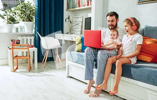 Image of father and his daughters at home