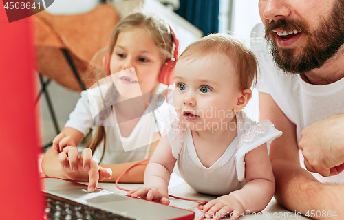 Image of father and his daughters at home