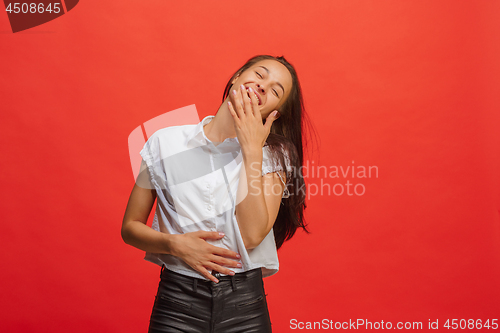 Image of The happy business woman standing and smiling against red background.