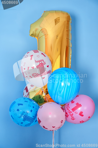 Image of first birthday balloons and golden digit one 1