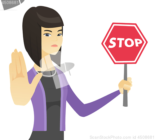 Image of Asian business woman holding stop road sign.