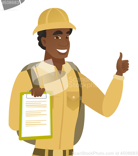 Image of African traveler with clipboard giving thumb up.