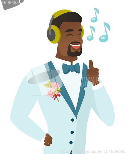 Image of African groom listening to music in headphones.