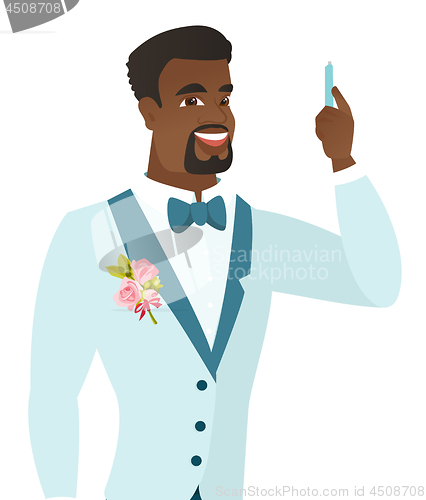 Image of Young african-american smiling groom with pen.