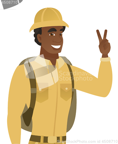 Image of African-american traveler showing victory gesture.