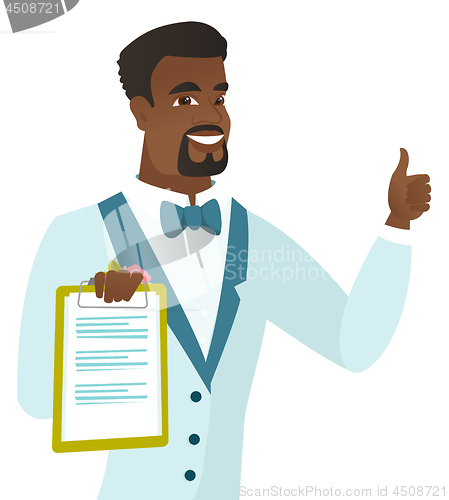 Image of Groom holding clipboard and giving thumb up.