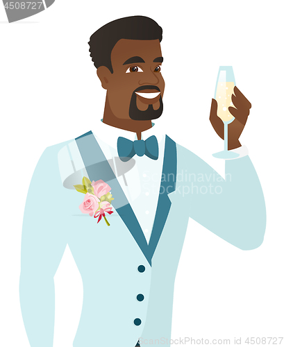 Image of African-american groom holding glass of champagne.