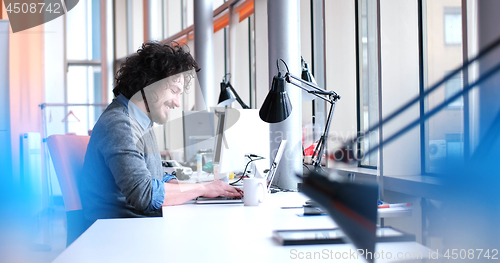 Image of businessman working using a laptop in startup office