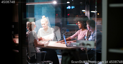Image of Multiethnic startup business team in night office