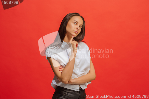 Image of Young serious thoughtful business woman. Doubt concept.