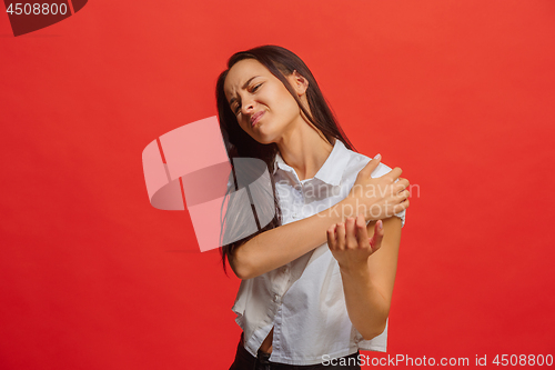 Image of Young woman overwhelmed with a pain in the shoulder