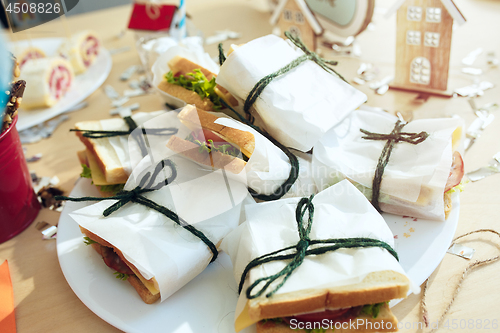 Image of Girl birthday decorations. table setting from above with cakes, drinks and party gadgets.