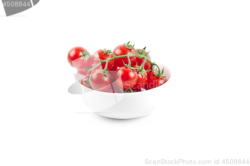 Image of Fresh organic cherry tomatoes bunch on ceramic bowl.