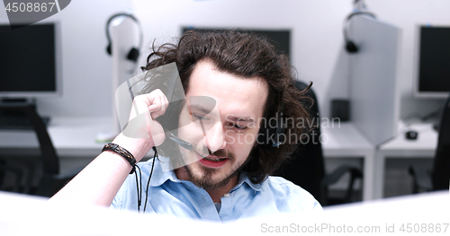 Image of male call centre operator doing his job