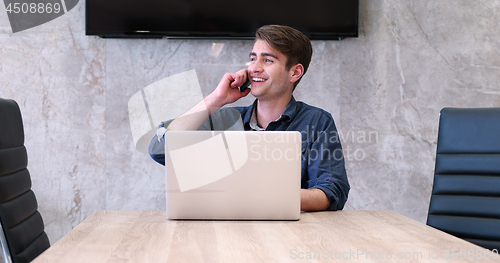 Image of businessman working using a laptop in startup office