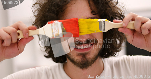 Image of man with funny hair over color background with brush