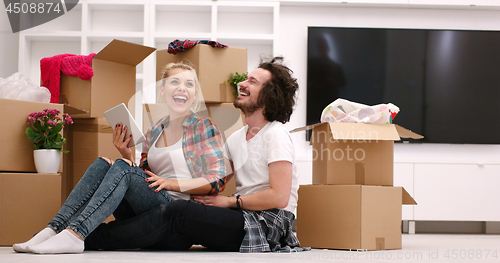 Image of young couple moving  in new house