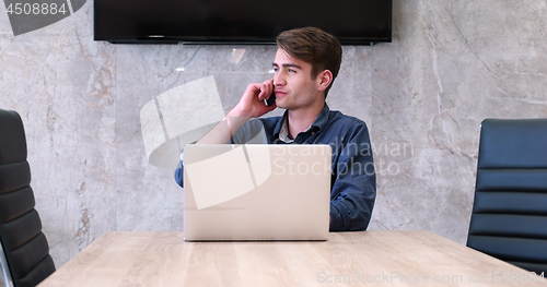 Image of businessman working using a laptop in startup office