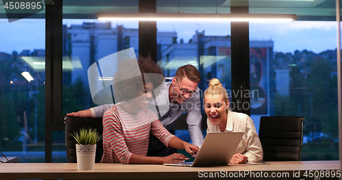 Image of Multiethnic startup business team in night office