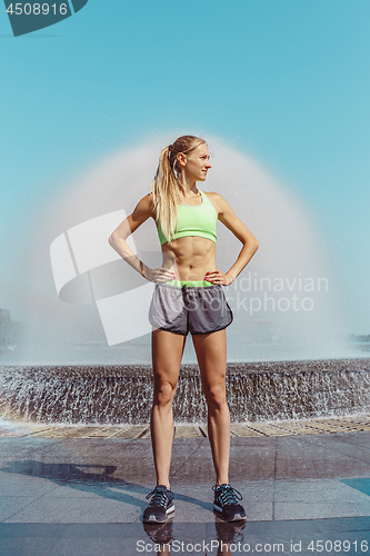 Image of Fit fitness woman posing at city