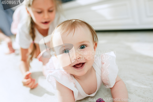 Image of adorable two sisters at bedroom