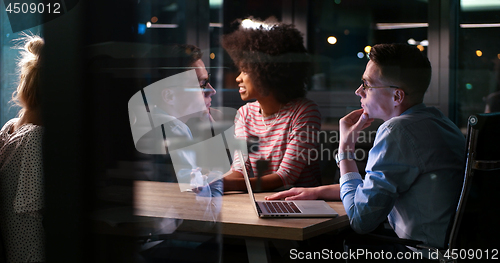 Image of Multiethnic startup business team in night office