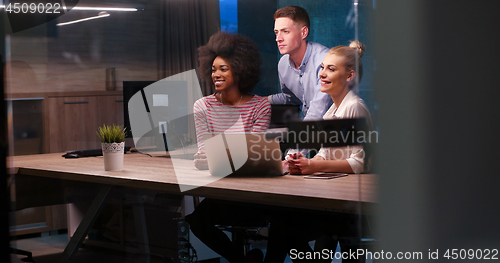 Image of Multiethnic startup business team in night office