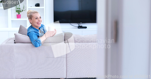 Image of woman enjoying a cup of coffee