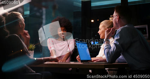 Image of Multiethnic startup business team in night office