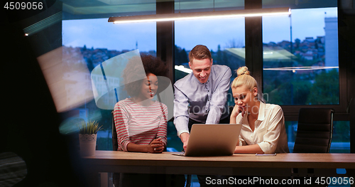 Image of Multiethnic startup business team in night office