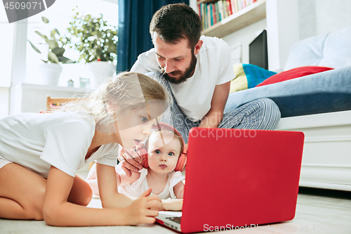 Image of father and his daughters at home