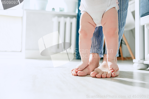 Image of father and his baby daughter at home