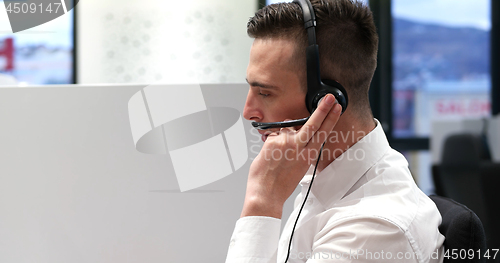 Image of male call centre operator doing his job